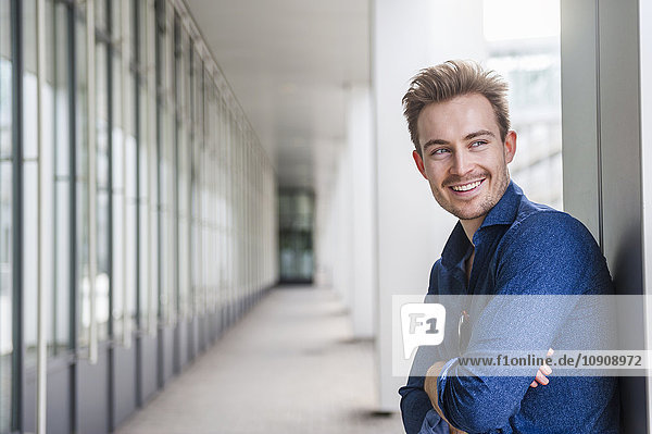 Portrait of relaxed young businessman with crossed arms