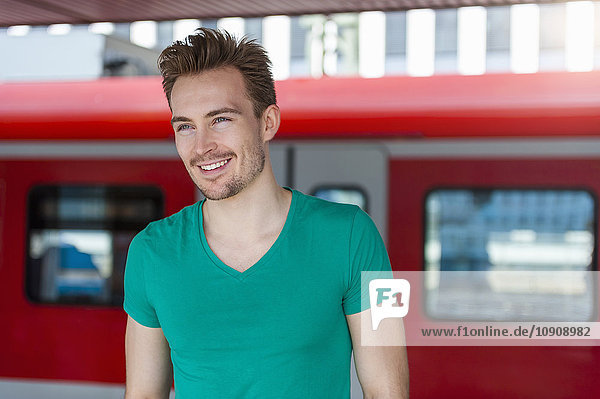 Portrait of smiling young man with stubble standing on platform