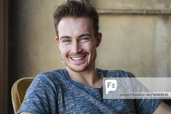Portrait of happy young man with stubble