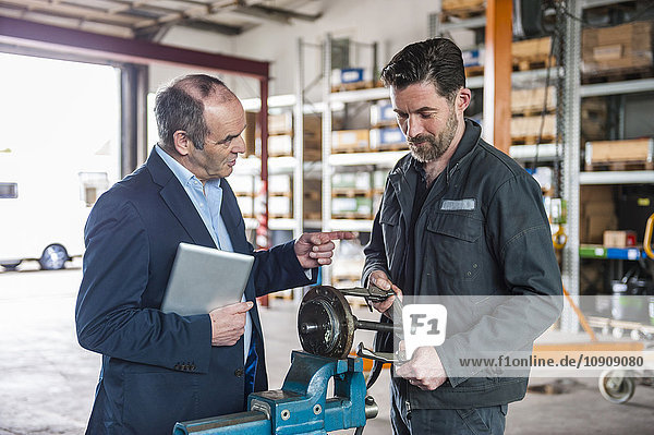 Engineer with digital tablet in workshop  man working