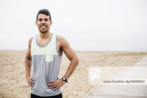 Portrait of smiling athlete on the beach