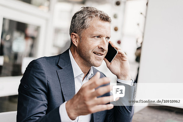 Geschäftsmann im Cafe mit Smartphone