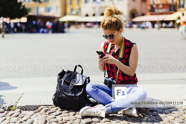 Italy  Verona  woman on town square looking at cell phone