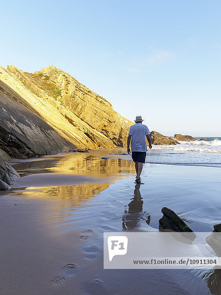 Portugal  Senior man taking a stroll at the beach