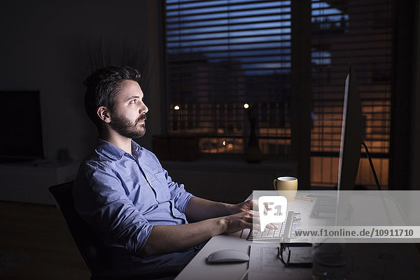 Man working at night  using computer