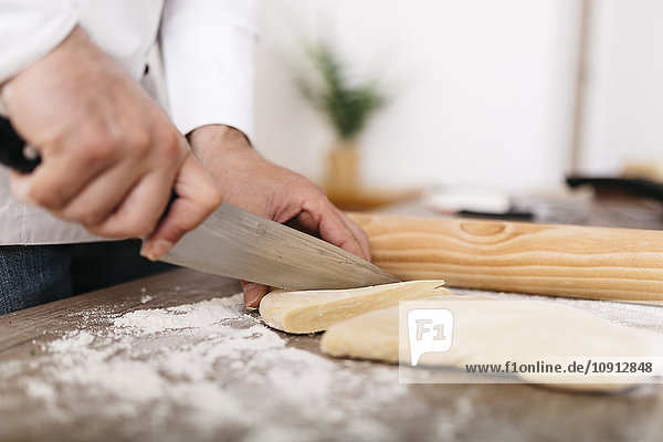 Chef cutting dough for fresh ravioli