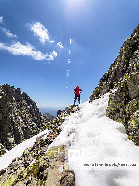 Spain  Sierra de Gredos  hiker standing on rock in mountainscape