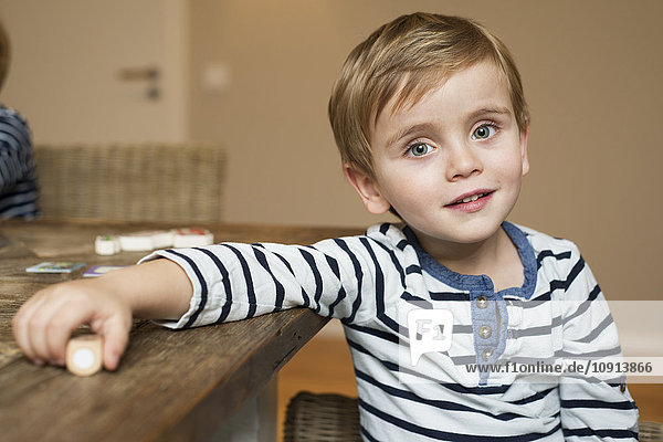 Liitle boy sitting at table  portrait