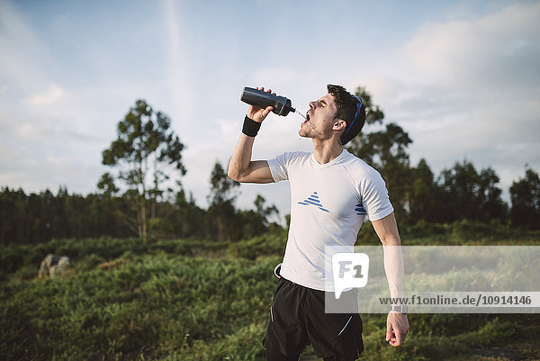 Trail runner  man drinking  drinking bottle
