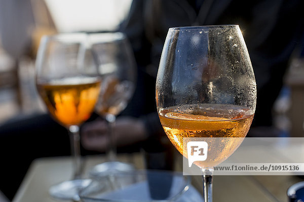 Glasses with aperitif in bar  close up