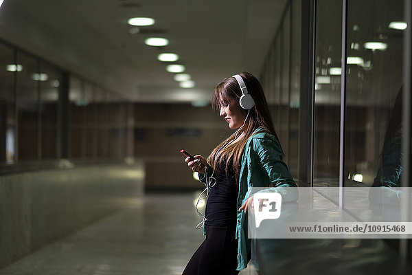 Young woman with headphones and smartphone