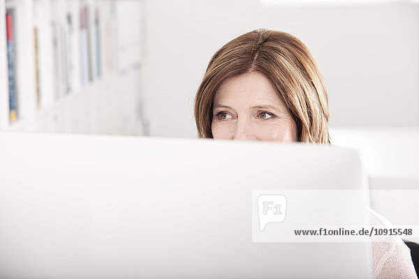 Portrait of woman behind her computer