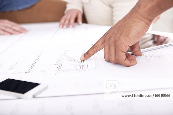 Hand pointing on construction plan