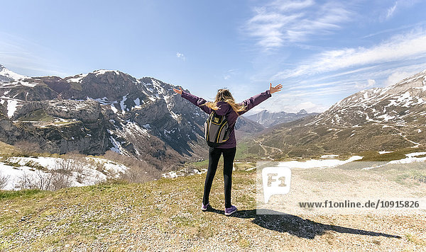 Spain  Asturias  Somiedo  woman standing with raised arms in mountains