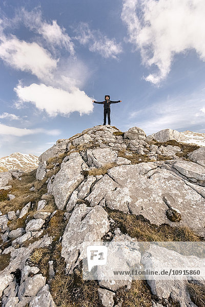 Spain  Asturias  Somiedo  man standing with outstretched arms in mountains