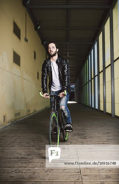 Young man riding fixie bike