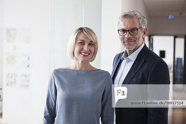 Businessman and woman in office  portrait