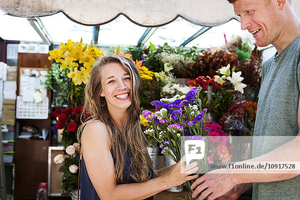 Mann verschenkt Blumen an seine Freundin