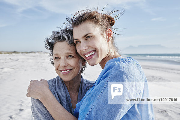 Portrait of mother and her adult daughter on the beach