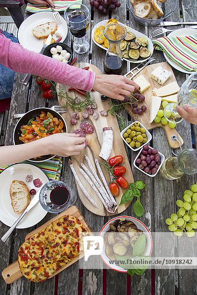 People enjoying variety of Mediterranean antipasti