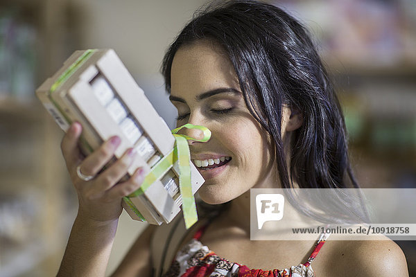 Woman smelling at scent product