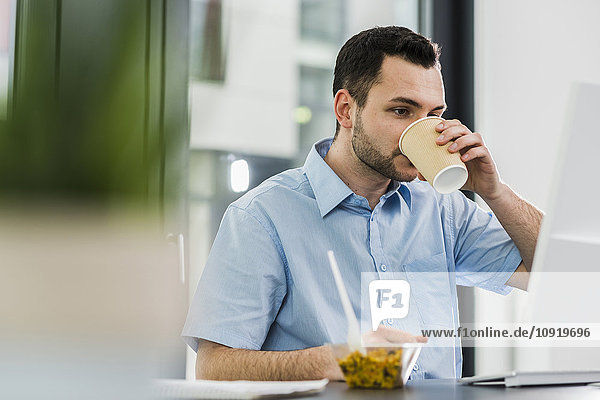 Business man in office  drinking coffee