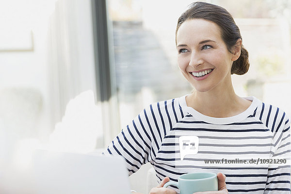 Smiling woman drinking coffee
