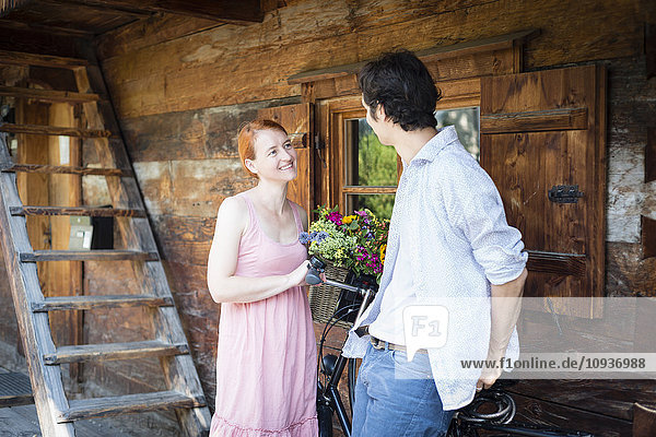 Happy couple in front of log cabin