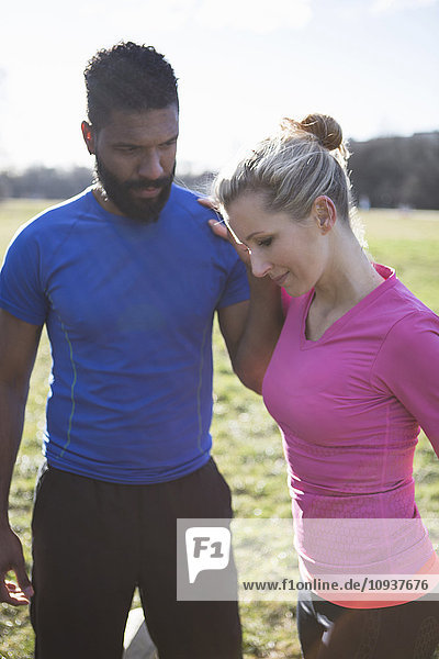 Young couple exercising in city park