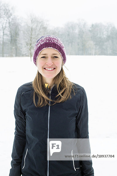 Mid adult woman in warm clothing and knit hat in winter