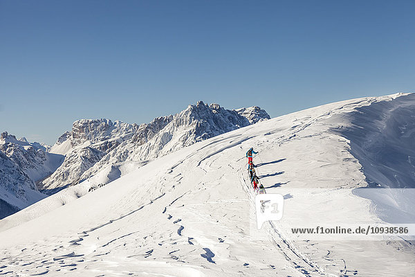 Group of ski tourers walking in Sexten Dolomites