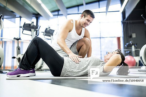 Woman exercising with trainer