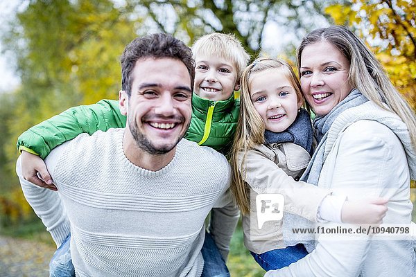 Portrait of family enjoying in autumn