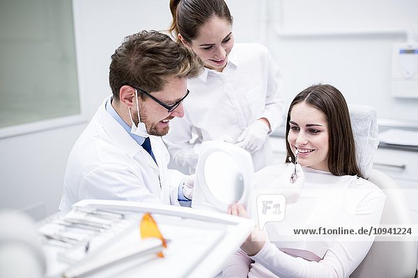 Dentist and patient with tooth veneers