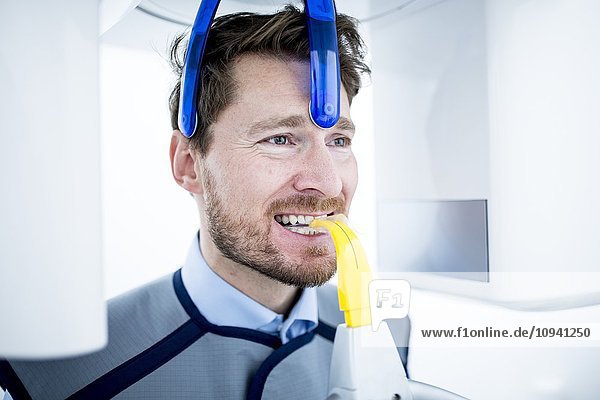 Mid Adult man having dental x-ray