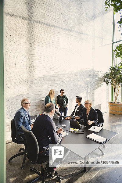 Multi-ethnic business people discussing in creative office