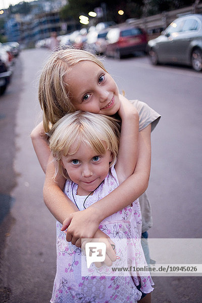 Two girls embracing  portrait