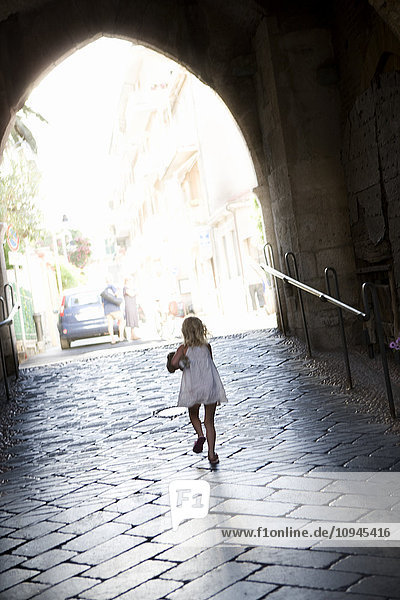 Italy  girl walking under archway