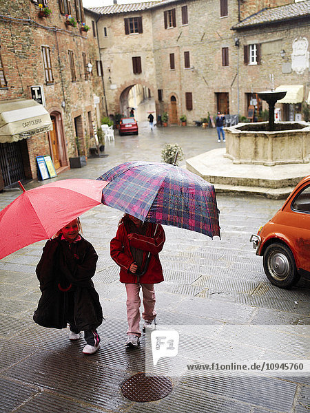 Zwei Mädchen mit großen Regenschirmen