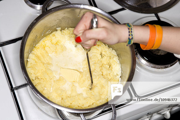 Girls hand mixing potato pure