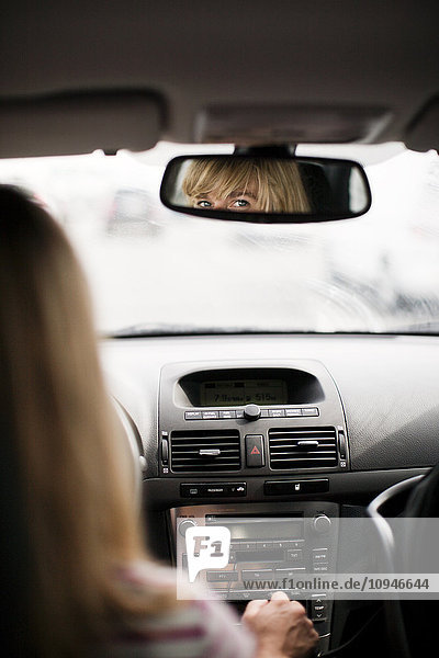 Blonde woman driving car