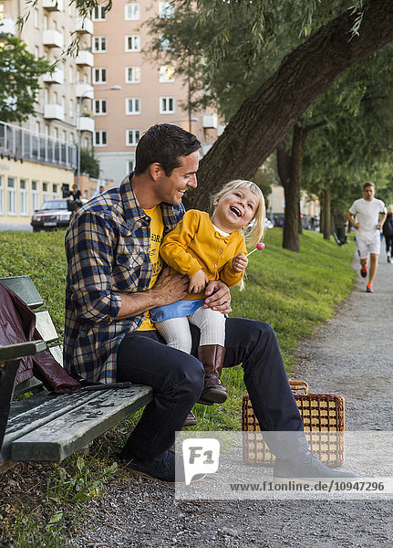Father with daughter on bench