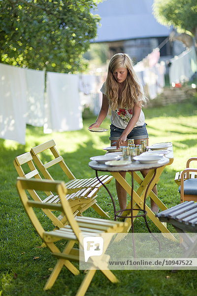 Girl setting outdoor table