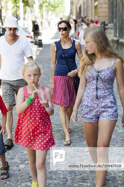 Family walking on cobblestone walkway