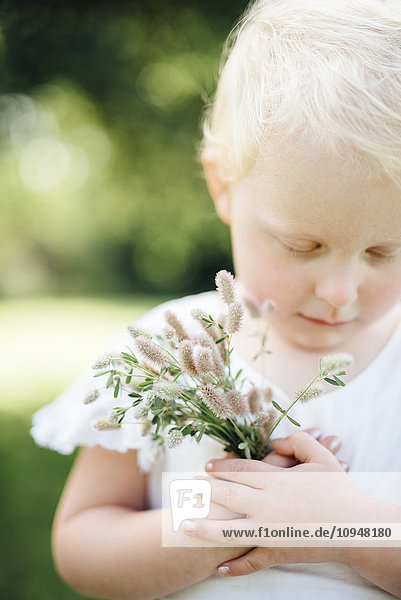 Girl holding wildflowers  close-up