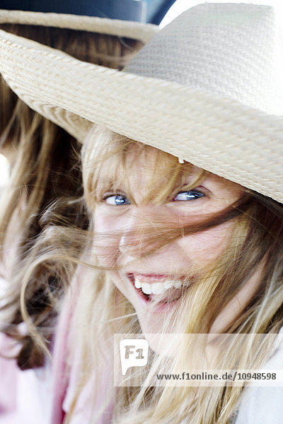 Portrait of laughing girl wearing hat