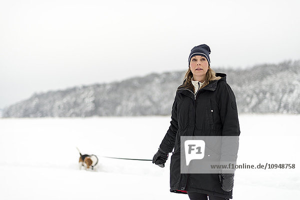 Woman walking dog at winter