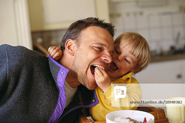 Junge füttert seinen Vater.