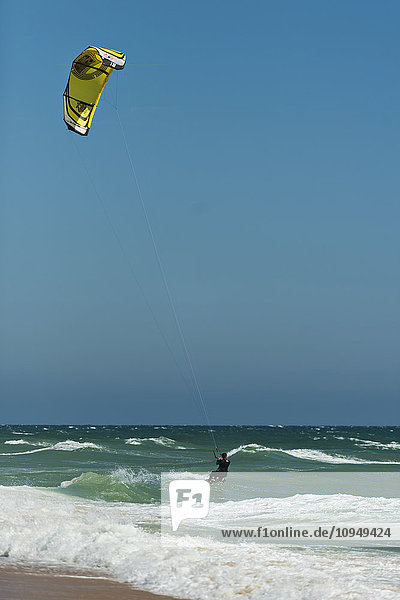 Mid adult man kite surfing