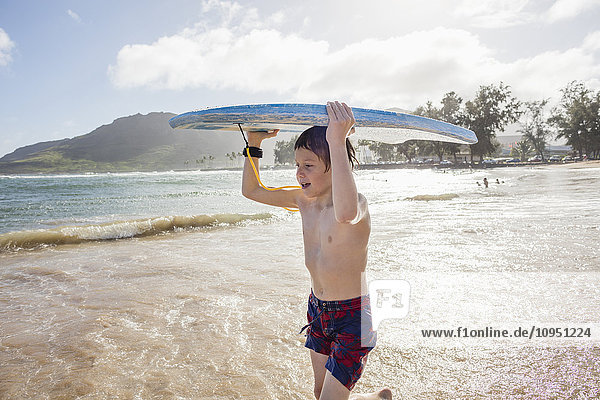 Boy with board on beach